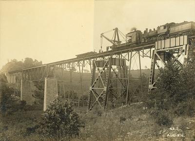 People working the train and crane for construction on the High Bridge