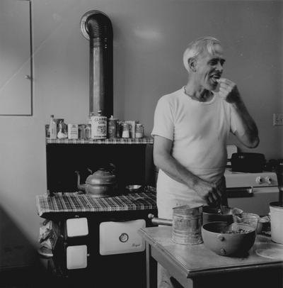 John Jacob Niles in the kitchen making blackberry pie, Boot Hill Farm