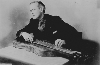 John Jacob Niles posed with dulcimer which he constructed; Harris and Ewing