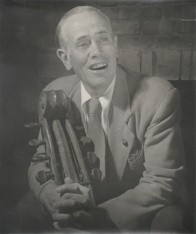 John Jacob Niles seated holding dulcimer