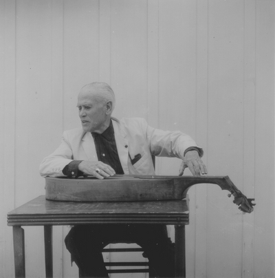 John Jacob Niles posed with dulcimer; Boot Hill Farm; Eugene Meatyard