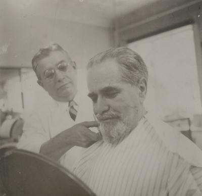 Alphonse Lipetz having his beard trimmed by the Italian barber; Albany, New York