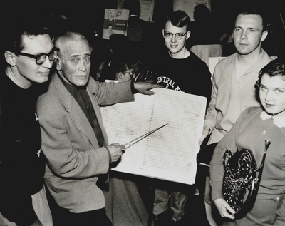 Members of Youth Orchestra and John Jacob Niles (second from left) look over score of 