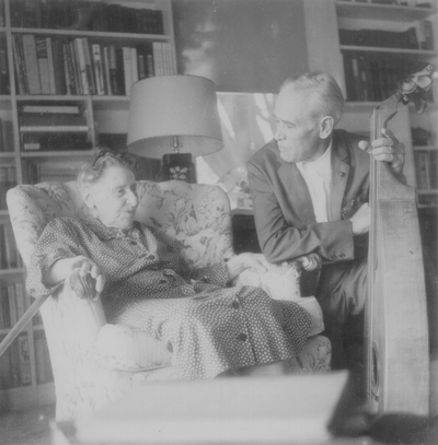 Miss Henrietta Child, daughter of folk songwriter Francis J. Child, seated with John Jacob Niles, taken at the home of Eleanor Churchill; Berea, KY