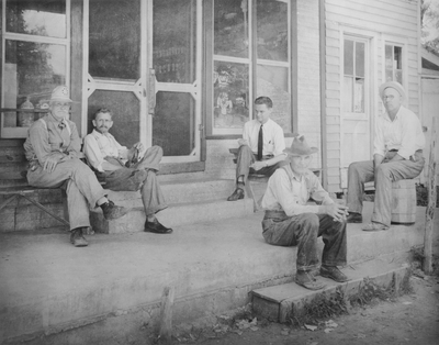 Men sitting on the front porch of a country store in Western Kentucky; John Jacob Niles