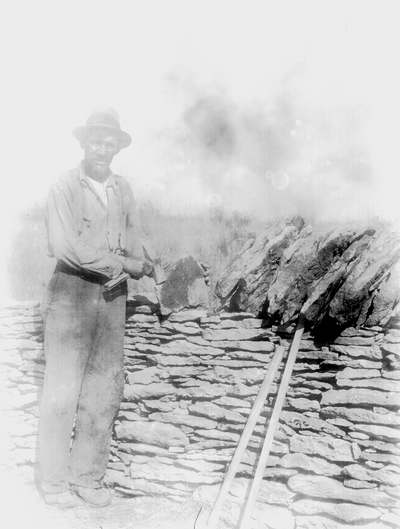 Robert Hicks building a stone wall at Boot Hill Farm