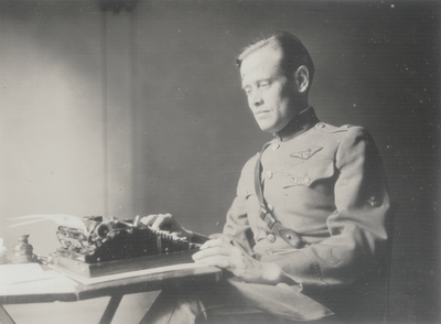 John Jacob Niles in uniform at typewriter
