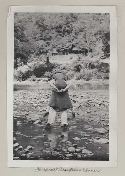 John Jacob Niles carrying Doris Ulmann across creek bed; John Jacob Niles and Doris Ulmann