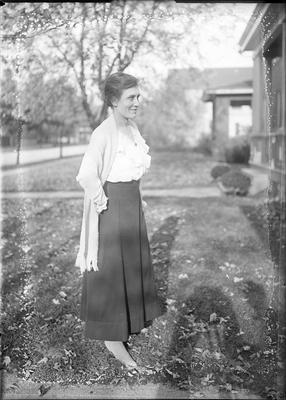 a woman standing in the front yard
