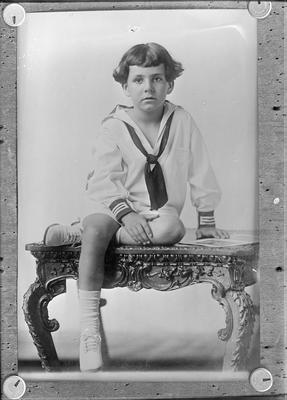 portrait of a young child, wearing a sailor style outfit, a copy negative