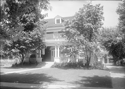 exterior of a house, partially hidden by trees