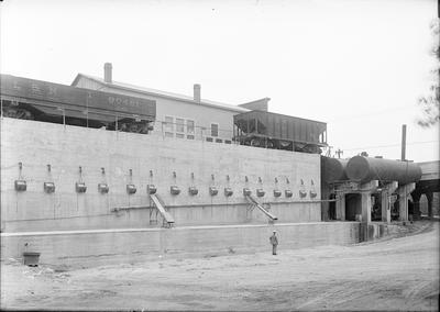 train on tracks, with a man standing below