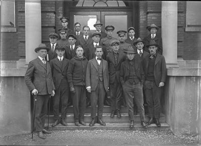 a group portrait of men taken on building steps