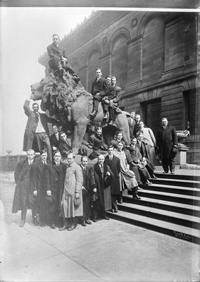 group portrait, gathered around a large lion statue