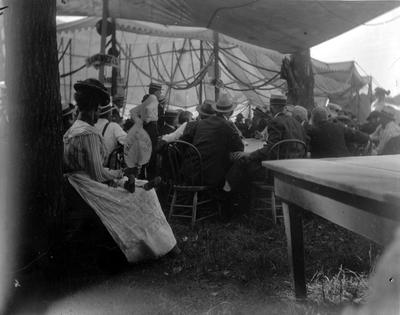 1902 Elks Fair, group of people sitting under a tent