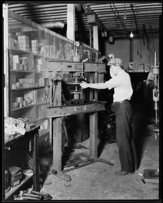 Man operating a drill press