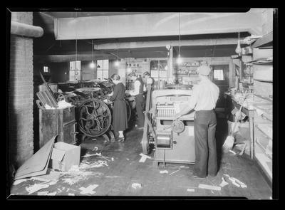 Men and women at printing press