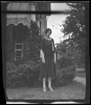 Well-dressed woman in yard