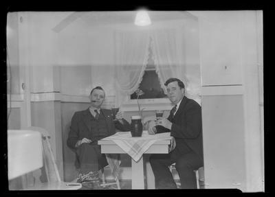 2 men in booth at a table