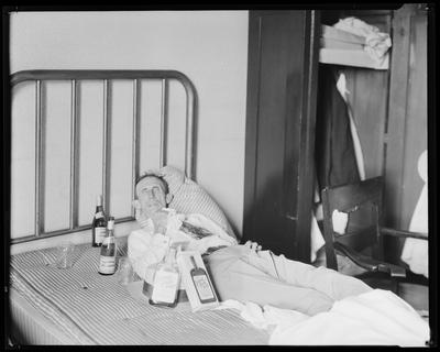 Old man w/ bottles on bed (Kentucky tavern, Canada Dry,                             etc.)