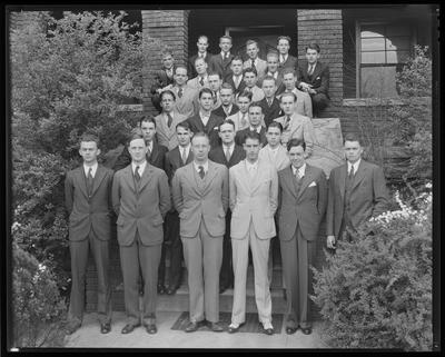 Young men in front of house