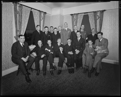 17 young men sitting around a sofa