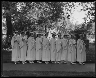 Women, holding diplomas