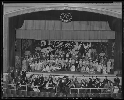 Cast in Oriental costumes on Henry Clay stage, w/ orchestra in                             pit