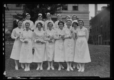 14 nurses, holding diplomas
