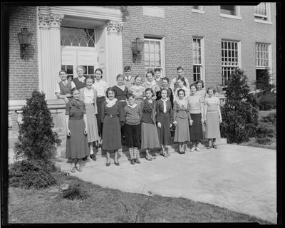 Young women standing in front of school