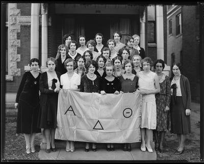 Young women, holding sorority banner (Alpha Delta                             Omega)