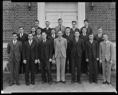 19 young men on steps