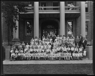 Students, faculty on building steps