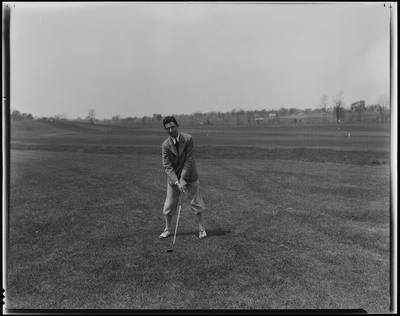 Young man in knickers, golfing