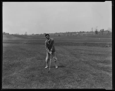 Young man in knickers, golfing