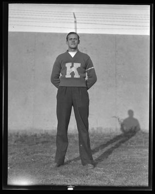 Football player, wearing letter sweater