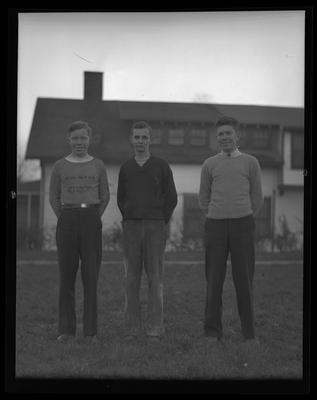 3 young men in letter sweaters