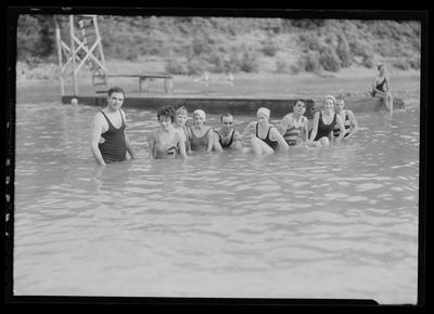 Men and women swimming in lake