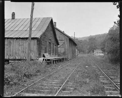 Dilapidated building by railroad tracks