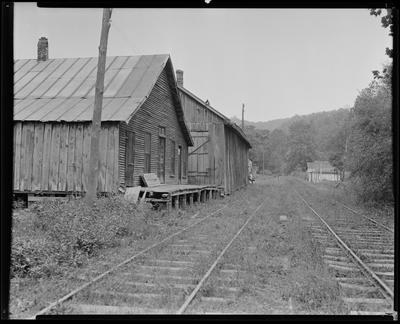 Dilapidated building by railroad tracks