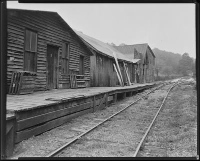 Dilapidated buildings by railroad tracks