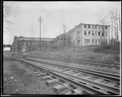 Railroad tracks, brick factory building