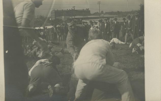 1910 Flag Rush (according to picture in 1910 year book) group of boys wrestling on the ground circa 1910