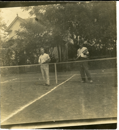 Two men on a tennis court circa 1914