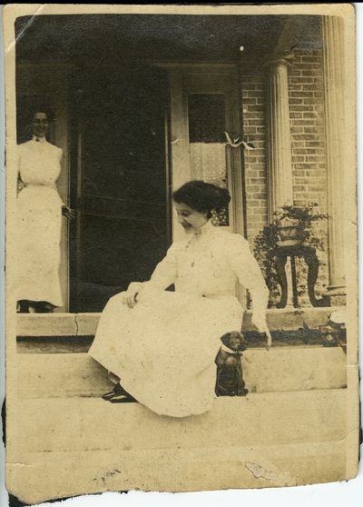 2 women on a porch with a puppy circa 1914