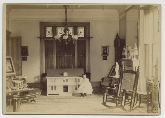 Interior view of Bell Place, including young Clara D. Bell