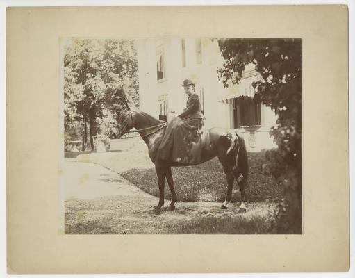 Clara D. Bell, as a young adult, with horse