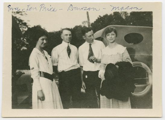 Eva? and Len Price, Dawson, Mason, standing in front of an automobile