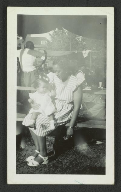 Joe Hodgen wife, unidentified black woman with an infant on her lap