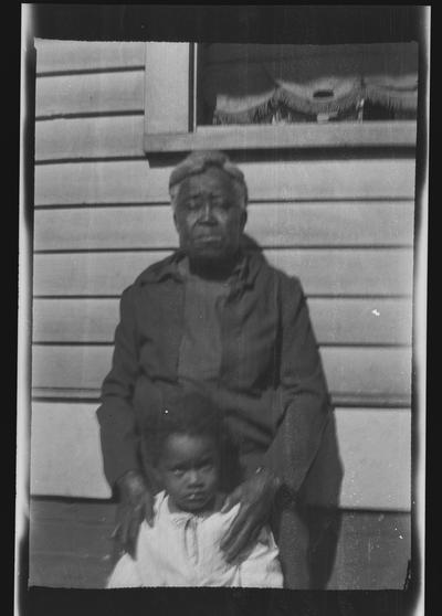 Negative of an unidentified man and child